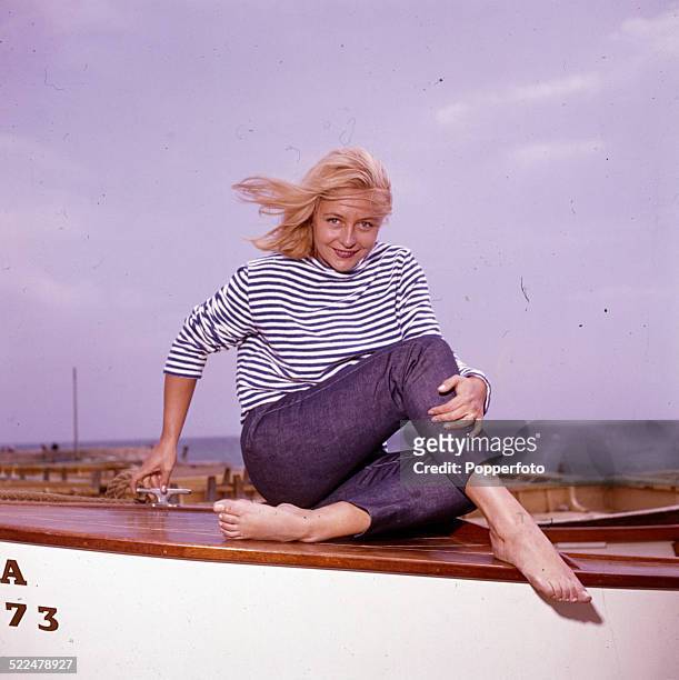 English actress Judy Cornwell posed on a rowing boat on an English beach in 1964.