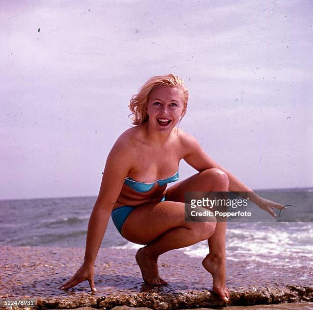 English actress Judy Cornwell posed wearing a light blue bikini on an English beach in 1964.