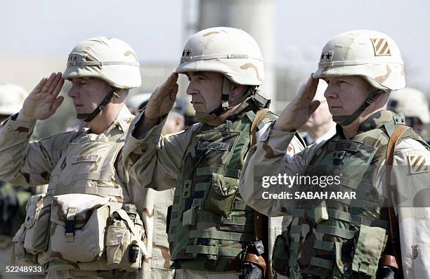 Incoming US Major General William Webster of the 3rd Infantry Division salutes along with outgoing Major General Peter Chiarelli and Lieutenant...