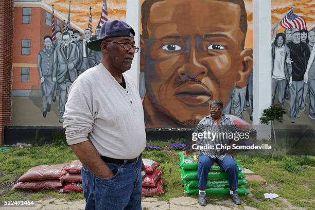 Harold Perry and his wife Jasalle Coates stand in their garden next to the mural of Freddie Gray that was painted on their home in memorial to Gray,...