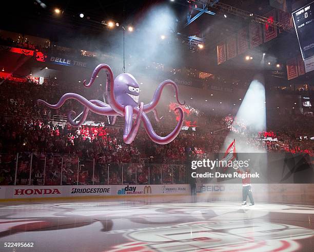 Darren McCarty holds a flag next to "Al the Octopus" during the pregame show prior to Game Four of the Eastern Conference First Round between the...