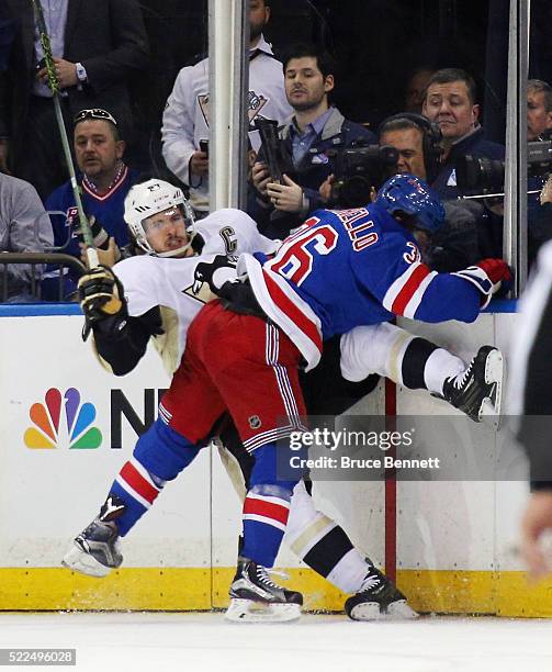 Sidney Crosby of the Pittsburgh Penguins is checked by Mats Zuccarello of the New York Rangers during the first period in Game Three of the Eastern...