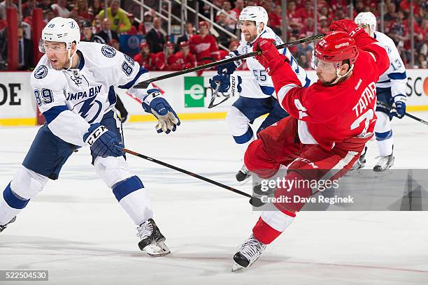 Tomas Tatar of the Detroit Red Wings shoots the puck while being defended by Nikita Nesterov of the Tampa Bay Lightning in Game Four of the Eastern...