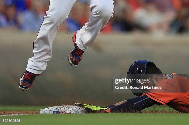 Marwin Gonzalez of the Houston Astros steals third base against Adrian Beltre of the Texas Rangers in the second inning at Globe Life Park in...