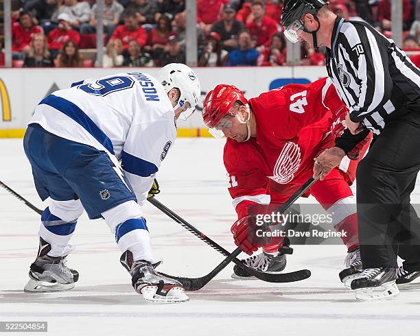 Tyler Johnson of the Tampa Bay Lightning faces off against Luke Glendening of the Detroit Red Wings in Game Four of the Eastern Conference First...