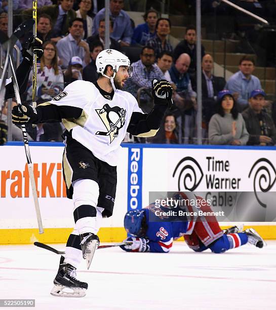 Kris Letang of the Pittsburgh Penguins celebrates his empty net goal at 19:47 of the third period as Mats Zuccarello of the New York Rangers hits the...