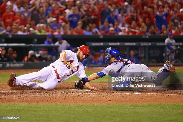 Matt Holliday of the St. Louis Cardinals is tagged out at home by Miguel Montero of the Chicago Cubs in the fourth inning at Busch Stadium on April...
