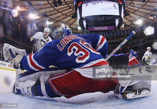 Henrik Lundqvist of the New York Rangers makes the save on Evgeni Malkin of the Pittsburgh Penguins in Game Three of the Eastern Conference First...