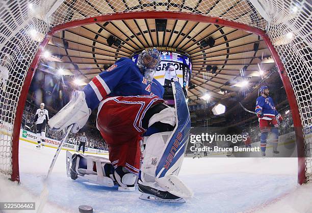 Henrik Lundqvist of the New York Rangers fishes the puck out of the net following a goal by Sidney Crosby of the Pittsburgh Penguins at 19:18 of the...