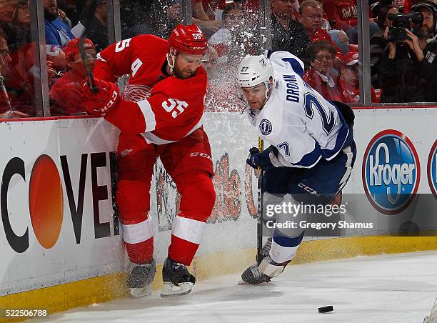 Niklas Kronwall of the Detroit Red Wings battles for the puck with Jonathan Drouin of the Tampa Bay Lightning during the third period of Game Four of...