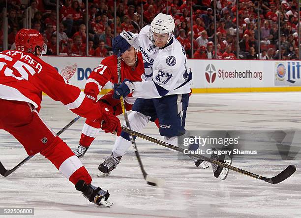 Jonathan Drouin of the Tampa Bay Lightning takes a shot between Danny DeKeyser and Dylan Larkin of the Detroit Red Wings during the third period of...