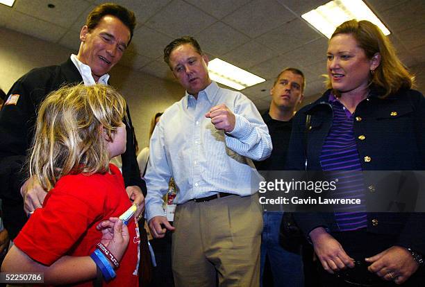 Chairman and CEO of NASCAR Brian France talks with California governor Arnold Schwarzenegger and his son Christopher during the NASCAR Nextel Cup...