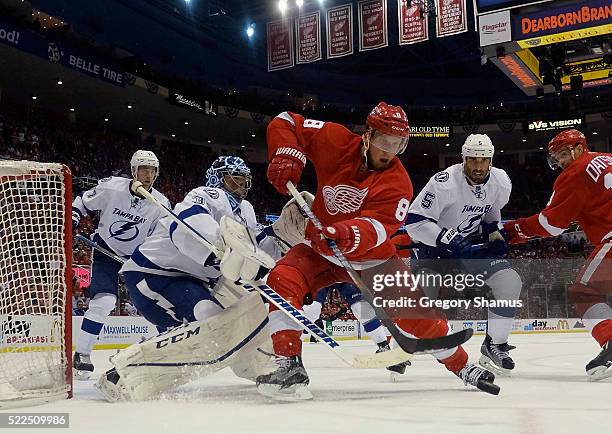 Justin Abdelkader of the Detroit Red Wings tries to control the puck in front of Ben Bishop of the Tampa Bay Lightning during the third period of...