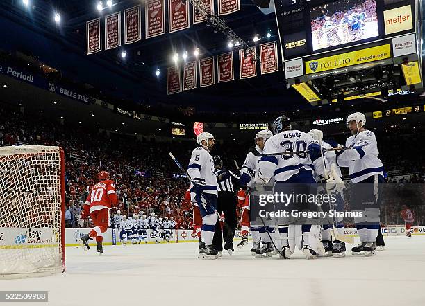 Ben Bishop of the Tampa Bay Lightning celebrates a 3-2 with teammates after Game Four of the Eastern Conference First Round during the 2016 NHL...