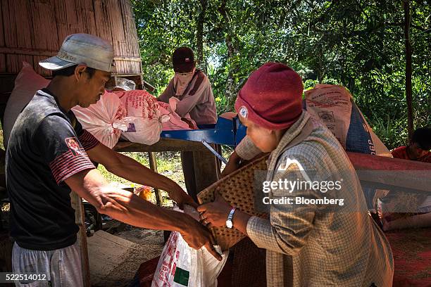 Iban workers use a machine to dehusk rice in the village of Lebor near Serian, Sarawak, Malaysia, on Thursday, April 14, 2016. Indifference to the...