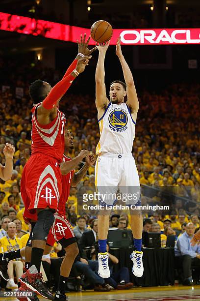 Klay Thompson of the Golden State Warriors shoots over Dwight Howard of the Houston Rockets in the third quarter in Game Two of the Western...