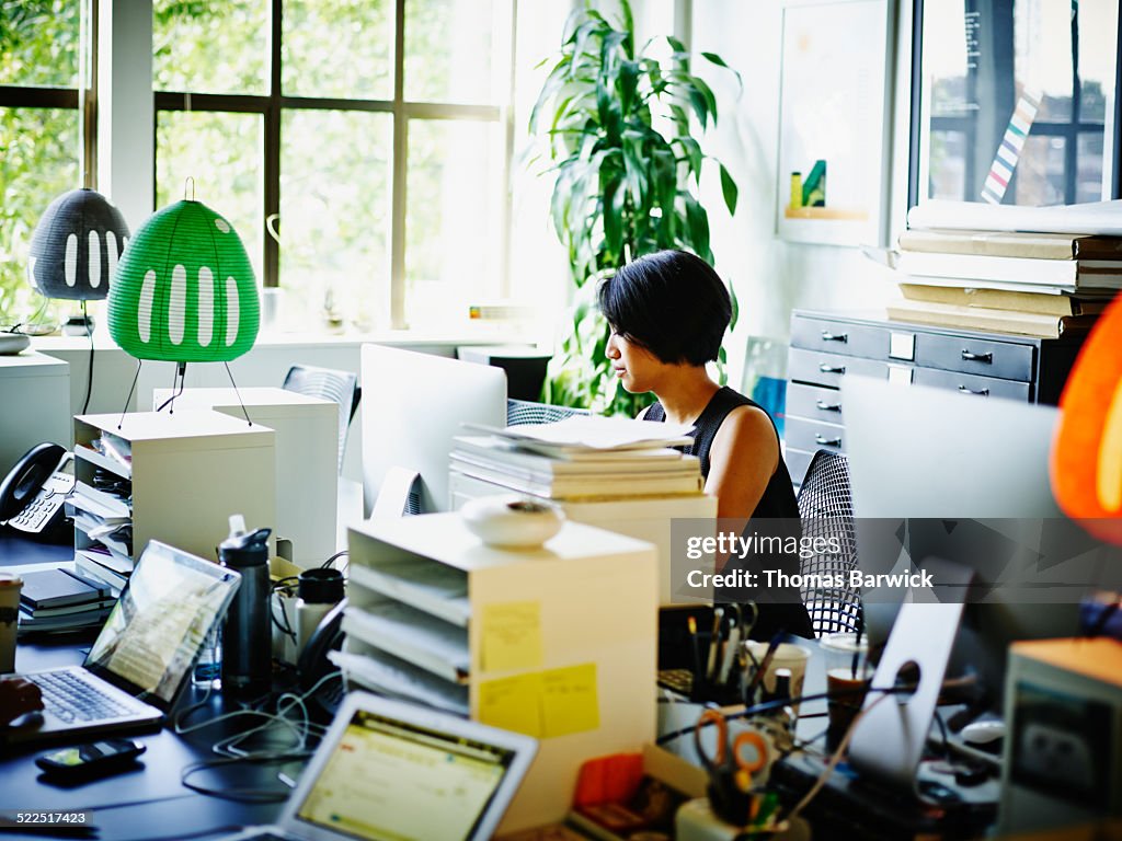 Businesswoman at workstation in startup office