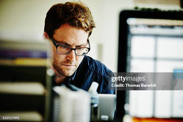 businessman working on laptop in startup office - image focus technique stock pictures, royalty-free photos & images