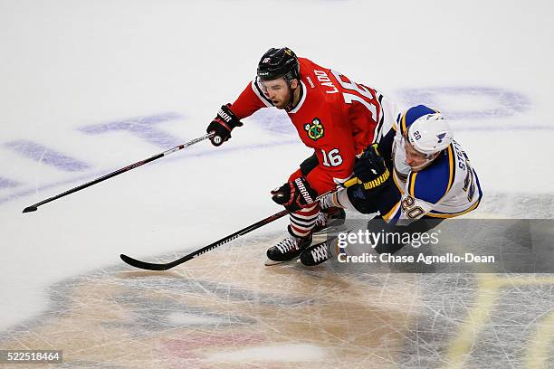 Andrew Ladd of the Chicago Blackhawks and Alexander Steen of the St. Louis Blues skate in the second period of Game Four of the Western Conference...