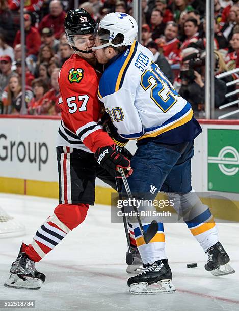 Trevor van Riemsdyk of the Chicago Blackhawks and Alexander Steen of the St. Louis Blues get physical in the second period of Game Four of the...