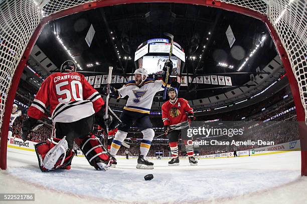 Steve Ott of the St. Louis Blues and Brent Seabrook of the Chicago Blackhawks watch the puck get past goalie Corey Crawford in the first period of...