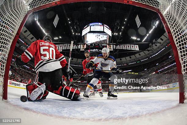 Steve Ott of the St. Louis Blues and Brent Seabrook of the Chicago Blackhawks watch the puck get past goalie Corey Crawford in the first period of...