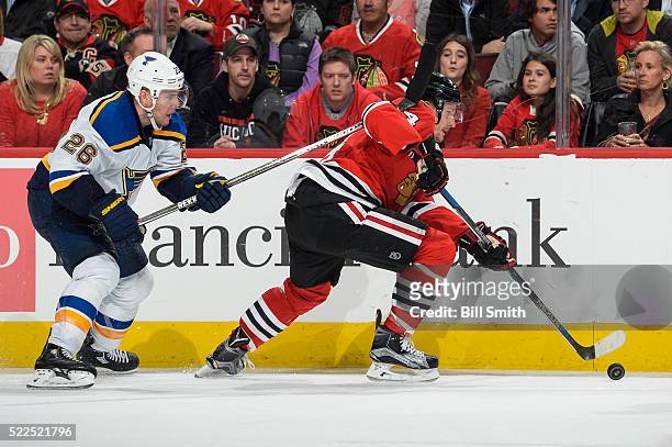 Richard Panik of the Chicago Blackhawks and Paul Stastny of the St. Louis Blues chase the puck in the third period of Game Four of the Western...