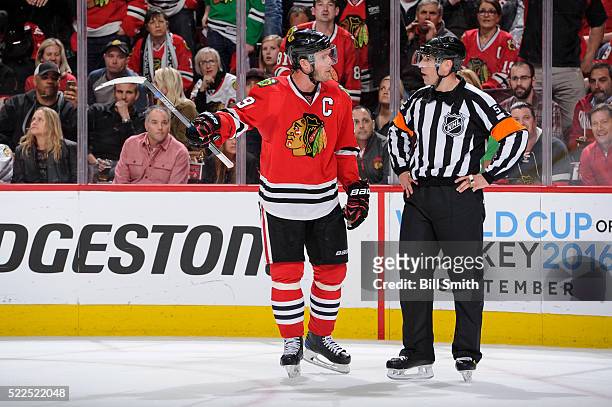 Jonathan Toews of the Chicago Blackhawks speaks with referee Chris Rooney in the third period of Game Four of the Western Conference First Round...