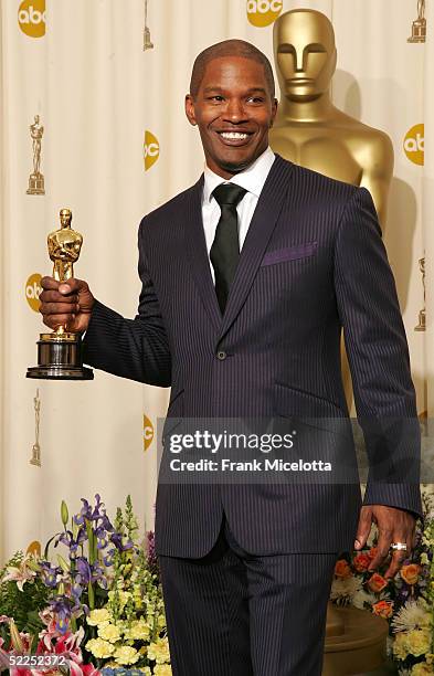 Actor Jamie Foxx and his award for "Best Actor in a Leading Role" for "Ray" poses backstage during the 77th Annual Academy Awards on February 27,...