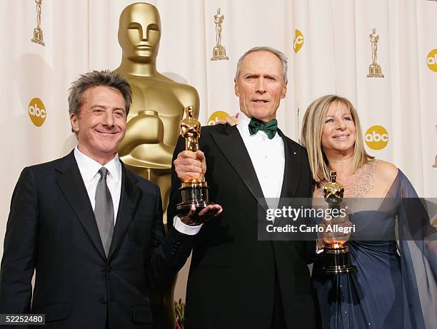 Actor Dustin Hoffman, Producer Clint Eastwood, and Actress Barbara Streisand pose with the award for Best Motion Picture for "Million Dollar Baby"...