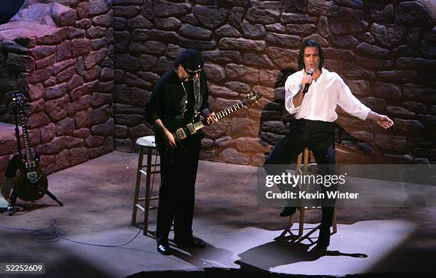 Musician Carlos Santana and Actor Antonio Banderes perform "Al Otro Lado del Rio" from "The Motorcycle Diaries" on stage during the 77th Annual...