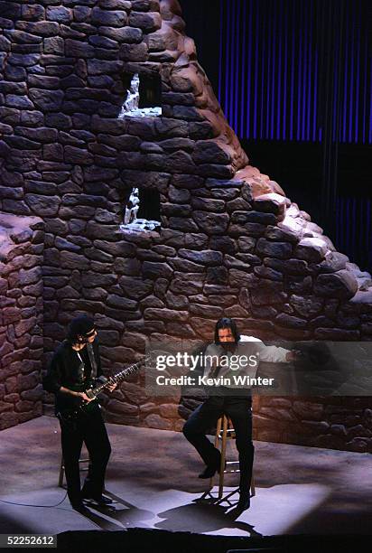 Musician Carlos Santana and Actor Antonio Banderes perform "Al Otro Lado del Rio" from "The Motorcycle Diaries" on stage during the 77th Annual...