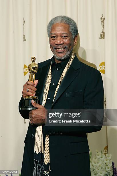Actor Morgan Freeman poses with his "Best Actor in a Supporting Role" award for his performance in "Million Dollar Baby" backstage during the 77th...