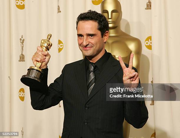 Composer Jorge Drexler poses with his "Achievement In Music" award for "Al Otro Lado Del Rio" featured in the film "The Motorcycle Diaries" backstage...
