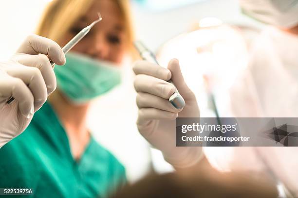 assistant at the dentist clinic - emergencies and disasters stock pictures, royalty-free photos & images