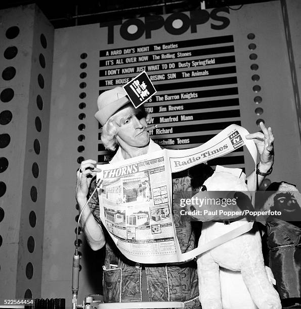 Radio and Television presenter Jimmy Savile, with a copy of the Radio Times during a photocall at the Dickenson Road Studios in Manchester, circa...