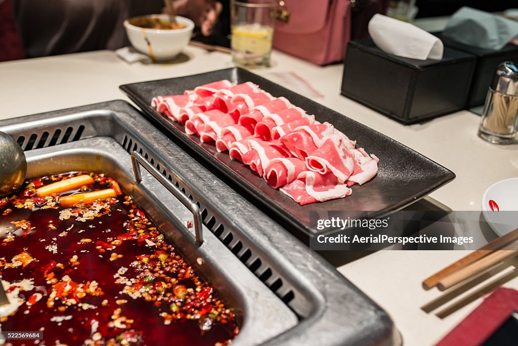 Plate of Thin Sliced Beef (Beef Rolls) and Spicy Sichuan Hot Pot