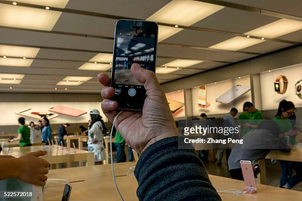 Chinese customer is trying out an iPhone SE in an Apple store located on Huaihai road. In China, Apple booked 3.4 million pre-orders for the iPhone...