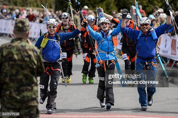 Pippa Middleton reacts next to teammates Tarquin Cooper and Bernie Shrosbree as they cross the finish-line of the "Patrouille des Glaciers" ski...