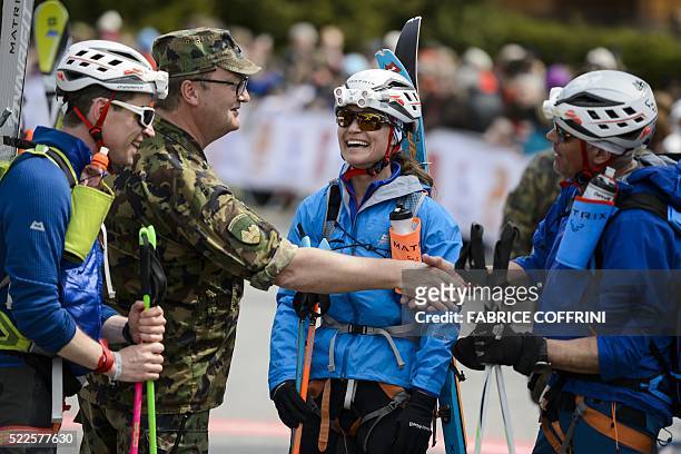 Pippa Middleton smiles next to her teammates Tarquin Cooper and Bernie Shrosbree as they are congratulated by an unidentified Swiss army officer...