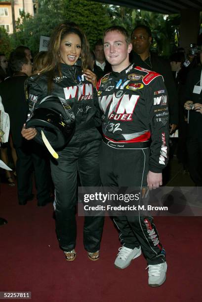 Actress Traci Bingham and NASCAR driver Shane Hmiel arrive at the 15th Annual "Night of 100 Stars" Oscar Party at the Beverly Hills Hotel on February...