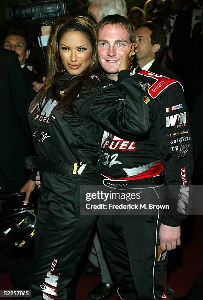 Actress Traci Bingham and NASCAR driver Shane Hmiel arrive at the 15th Annual "Night of 100 Stars" Oscar Party at the Beverly Hills Hotel on February...