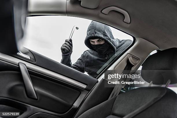 thief in a mask hijacks the car - kapa bildbanksfoton och bilder