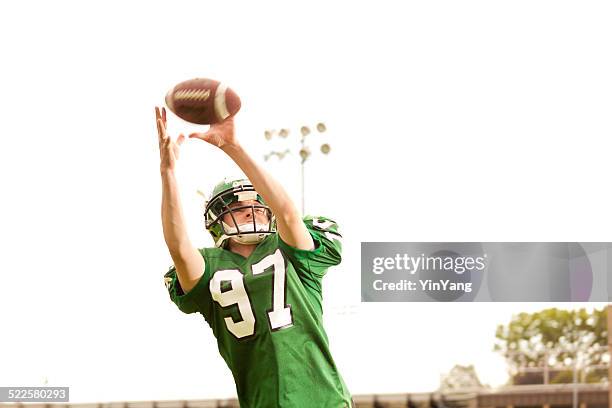 american football player receiver in action - high school stock pictures, royalty-free photos & images