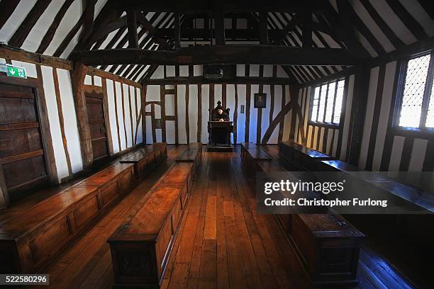 Performance guide Sam Lesser poses in the former schoolroom of William Shakespeare at King Edward VI School on April 20, 2016 in Stratford-upon-Avon,...