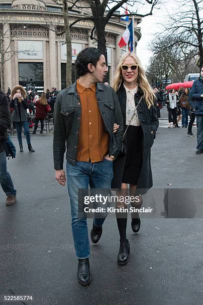 Guest with Actress Chloë Sevigny wears all Miu Miu on day 9 during Paris Fashion Week Autumn/Winter 2016/17 on March 9, 2016 in Paris, France. A...