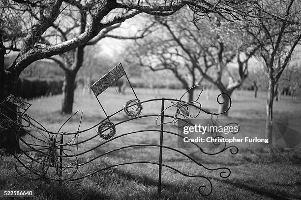 Sculpture adorns the orchard in the garden of Anne Hathaway's Cottage on April 19, 2016 in Stratford-upon-Avon, England. 2016 is the 400th...