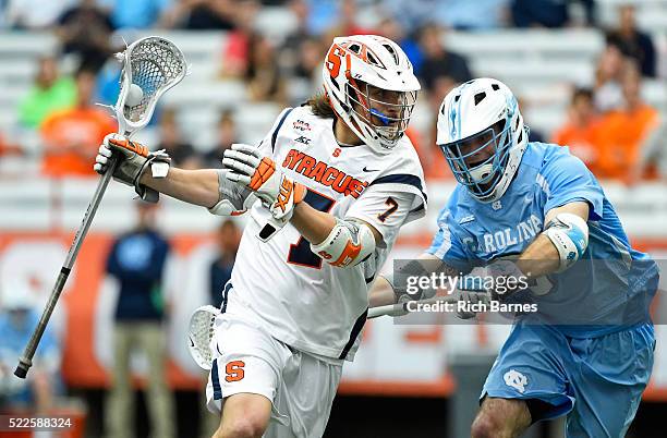 Brad McKinney of the Syracuse Orange dodges to the goal against the defense of Brett Bedard of the North Carolina Tar Heels during the second quarter...