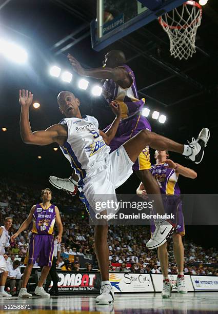 Derek Rucker of the Brisbane Bullets is blocked by Roland Roberts of the Kings during the first of three NBL Semi-final matches between the Sydney...