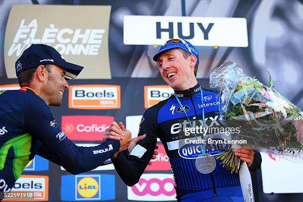 Third-placed Dan Martin of Ireland and Etixx - Quick Step shakes hands with the winner Alejandro Valverde of Spain and Movistar on the podium after...